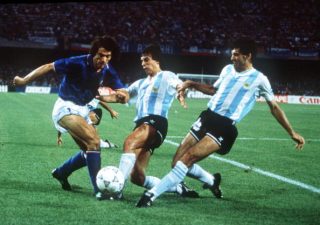 1990 World Cup Semi Final. Naples, Italy. 3rd July, 1990. Argentina 1 v Italy 1 (Argentina win 3-2 on penalties). Italy’s Roberto Donadoni is challenged for the ball by Argentina’s Juan Ernesto Simon and Jose Basualdo.