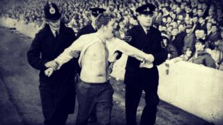 an-everton-fan-is-led-away-by-two-policemen-during-the-match-against-burnley-at-goodison-park